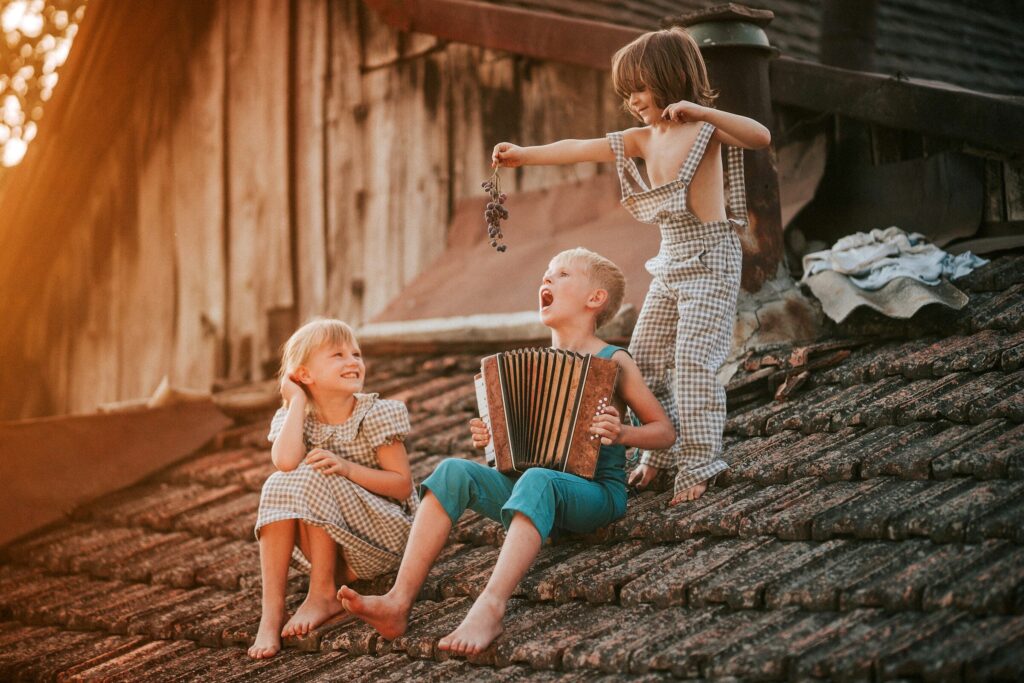 a group of children sitting on top of a roof