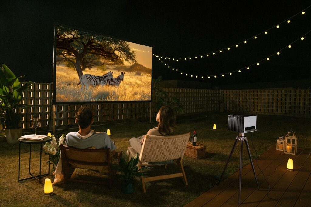 Couple enjoys a movie night outdoors.
